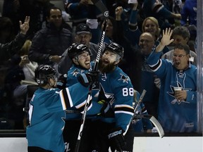 Logan Couture (#39) of the San Jose Sharks is congratulated by Brent Burns (#88) and Joonas Donskoi (#27) after Couture scored in the second period against the Nashville Predators  in Game Seven of the Western Conference Second Round during the 2016 NHL Stanley Cup Playoffs at SAP Center on May 12, 2016 in San Jose, California.