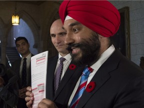 Navdeep Bains, the minister of Innovation, Science and Economic Development, holds up a copy of the long-form census.
