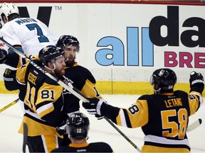 Pittsburgh Penguins' Nick Bonino, centre, celebrates his game-winning goal against the San Jose Sharks with Phil Kessel (81) and Kris Letang (58) during the third period in Game 1 of the Stanley Cup final series Monday, May 30, 2016, in Pittsburgh.