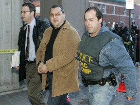 Police bring Francesco Del Balso one of the key suspects in a mafia sting is escorted to RCMP headquarters during an early morning round up of more than 90 people on Wednesday, November 22, 2006 in Montreal.