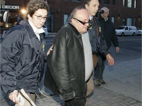 Police bring Rocco Sollecito to RCMP headquarters during a round up of more than 90 people on Wednesday, Nov. 22, 2006, in Montreal.