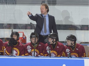 Quispamsis, NB - April 24 2016 - Lac St. Louis Lions coach Jon Goyens gives instructions behind the bench during bronze medal game against the Lloydminster Bobcats at the 2016 TELUS Cup at the Quispzmsis QPlex in Quispamsis, New Brunswick. (Photo: Matthew Murnaghan/Hockey Canada Images)