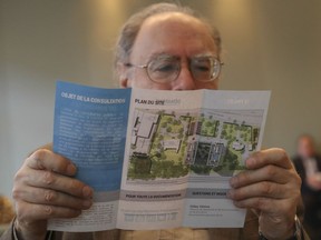 Robert Hajaly looks at an information brochure prior to the start of an information session before public consultations at the city's public-consultation office in Montreal Thursday, May 12, 2016 regarding the building of a 20-storey twin condo tower project that is being proposed for the site of the former Franciscan church that burned down on René-Lévesque Blvd.
