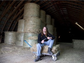 Shawn Soucy holds his pocket knife in the barn of his family farm in Saint-Rémi.