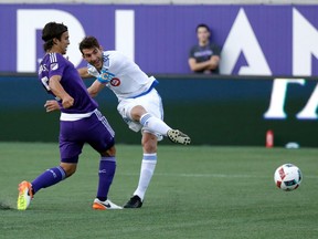 Montreal Impact's Ignacio Piatti, right, scores a goal on a shot past Orlando City's Servando Carrasco during the first half of an MLS soccer game, Saturday, May 21, 2016, in Orlando, Fla.