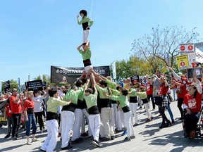 "Castellers" make a human tower during a demonstration called by several organizations and people affected by th hepatitis C virus (HCV) demanding the need to ensure universal access to these treatments, outside the "International Liver Congress" in Barcelona, on April 16, 2016.