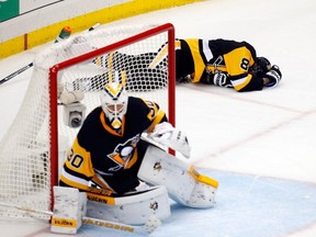 Brian Dumoulin of the Pittsburgh Penguins lays on the ice in pain during the third period against the Tampa Bay Lightning in Game One of the Eastern Conference Final during the 2016 NHL Stanley Cup Playoffs on May 13, 2016 in Pittsburgh.