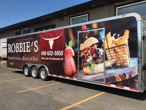 The owners of a Kahnawake restaurant are scratching their heads after a 30-foot trailer, shown in this handout image, emblazoned with their logo, phone number, and photos of a giant hamburger was stolen Friday night.