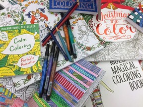 This Dec. 8, 2015 photo shows a display of adult colouring books and markers in New York. It's the newest anxiety-relieving craze.