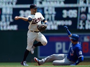 Troy Tulowitzki of the Toronto Blue Jays is out at second base as Brian Dozier of the Minnesota Twins turns a double play during the second inning of the game on May 21, 2016, at Target Field in Minneapolis.