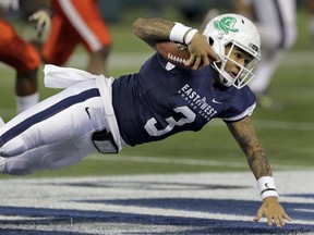 West quarterback Vernon Adams Jr., (3), of Oregon, dives for yardage after getting tripped up by East defensive end Victor Ochi (91), of Stony Brook, during the first half of the East West Shrine football game Saturday, Jan. 23, 2016, in St. Petersburg, Fla.