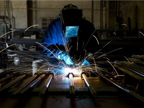 Welder Al Macchione works at custom manufacturer Fox Company Inc., Wednesday, July 16, 2014, in Philadelphia.