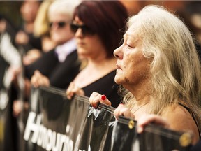 Women take a stand against domestic violence on Sept. 23, 2015, as Basil Borutski appeared in court to face first-degree murder charges. The Ottawa Citizen's newsroom was honoured with a National Newspaper Award for its coverage of the crime and its victims.