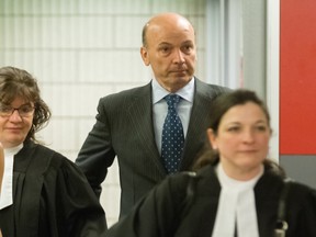 Former Montreal executive-committee chairman Frank Zampino, centre, leaves a Montreal courtroom in June 2016. He and others are on trial for corruption.
