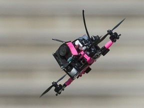A drone flies the course during a race at the Montreal Drone Expo, Saturday, June 25, 2016.
