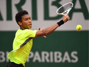 Montreal's Félix Auger-Aliassime hits a backhand during the boys' singles final match against Geoffrey Blancaneaux of France on Day 15 of the French Open at Roland Garros on June 5, 2016 in Paris, France.