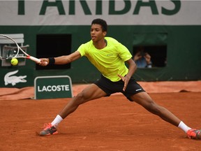 Félix Auger Aliassime of canada hits a forehand during the Boys Singles final match against Geoffrey Blancaneaux of France on day fifteen of the 2016 French Open at Roland Garros on June 5, 2016 in Paris, France.