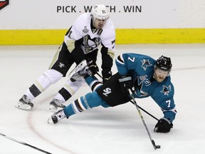 Paul Martin of the San Jose Sharks skates for the puck against Evgeni Malkin of the Pittsburgh Penguins during the first period in Game Three of the 2016 NHL Stanley Cup Final at SAP Center on June 4, 2016, in San Jose.