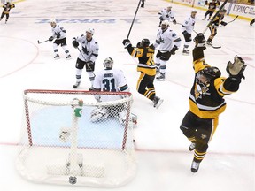 The Pittsburgh Penguins celebrate after Conor Sheary (#43) scored the game-winning goal against Martin Jones (#31) of the San Jose Sharks to win 2-1 in overtime during Game Two of the 2016 NHL Stanley Cup Final at Consol Energy Center on June 1, 2016 in Pittsburgh, Pennsylvania.