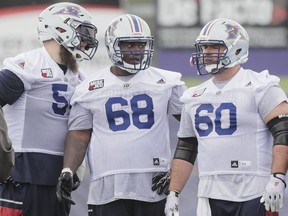 Tackle Jeff Perrett, left, guard Philip Blake and centre Dominic Picard take part in the Montreal Alouettes training camp at Bishop's University in Lennoxville on Sunday, May 29, 2016.