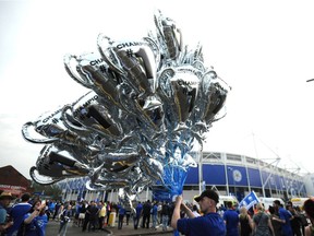 A vendor sells balloons in the shape of the trophy after the English Premier League soccer match between Leicester City and Everton at the King Power Stadium in Leicester, England, Saturday, May 7, 2016.
