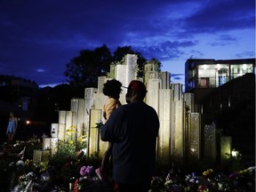 Andrew Hale, right, holds his daughter Chloe, 3, both of Louisville, as he explains to her who Muhammad Ali was as they visit a makeshift memorial to him at the Muhammad Ali Center, Saturday, June 4, 2016, in Louisville, Ky. "He was strong, courageous, and I hope I can be like that one day and just show love to my daughter like he showed his. That's what I was explaining to her," said Hale. "She asked me where he is and I said he was in heaven."