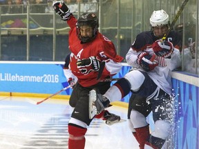 BenoÎt-Olivier Groulx of Canada, left, crashes into Mattias Samuelsson of the U.S. during their hockey men's final between Canada and U.S.A. at the Kristins Hall during the Winter Youth Olympic Games, Lillehammer, Norway, Sunday, Feb. 21, 2016.