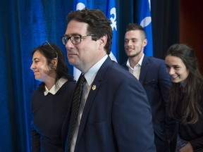 Parti Québécois house leader Bernard Drainville walks away with his wife Martine Forand and his children Lambert and Rosalie after announcing his resignation from politics during a news conference in his riding in Longueuil, Que. Tuesday, June 14, 2016.