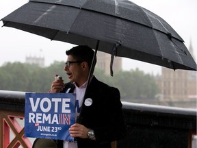 Campaigners hold placards for 'Britain Stronger in Europe', the official 'Remain' campaign group seeking to avoid a Brexit, ahead of the forthcoming EU referendum, in London on June 20, 2016.  /