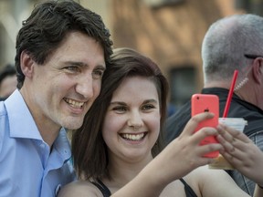 Canadian Prime Minister Justin Trudeau has his photo taken as he visits a street party for Fete Nationale in Montreal on Friday, June 24, 2016.