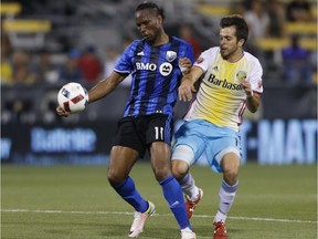 Columbus Crew midfielder Rodrigo Saravia, right, and Montreal Impact forward Didier Drogba fight for the ball during the second half of an MLS soccer match Saturday, June 18, 2016, in Columbus, Ohio.