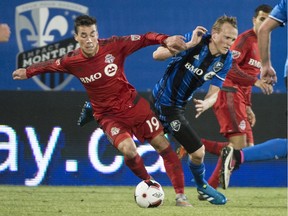 Toronto FC midfielder Daniel Lovitz (19) controls the ball as Montreal Impact midfielder Wandrille Lefevre defends during second half Amway Canadian Championship semifinal action Wednesday, June 8, 2016 in Montreal.