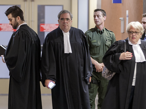 Dennis Galiatsatos, prosecutor in the trial of Richard Henri Bain, left, defence lawyers Alan Guttman, second from left, and Andrée Marier, right, and Surete du Quebec bomb expert witness Alain Lemieux, second from right, leave a courtroom during a break in the trial at the Montreal Courthouse on Tuesday, June 21, 2016
