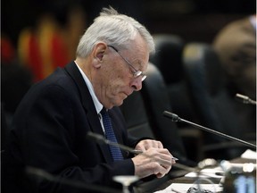 In this Nov. 18, 2015, file photo, Dick Pound, the author of a report that detailed anti-doping corruption in Russia, prepares during a break in a meeting of the World Anti-Doping Agency in Colorado Springs, Colo.