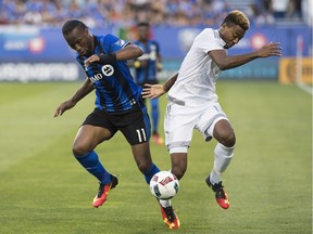 Montreal Impact's Didier Drogba (11) challenges Sporting Kansas City's Saad Abdul-Salaam  on Saturday. The game ended in a 2-2 draw.