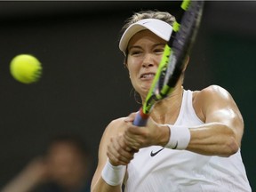 Eugenie Bouchard of Canada hits a return to Magdalena Rybarikova of Slovakia during their women's singles match on Day 3 at Wimbledon, Wednesday, June 29, 2016.