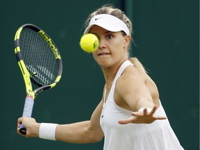 Westmount's Eugenie Bouchard hits return against Slovakia's Magdalena Rybarikova during their first-round match on Tuesday at Wimbledon.