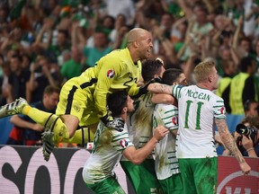 Ireland's midfielder Robert Brady celebrates scoring a goal with team mates during the Euro 2016 group E football match between Italy and Ireland at the Pierre-Mauroy stadium in Villeneuve-d'Ascq, near Lille, on June 22, 2016. Ireland won the match 0-1.