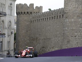 Kimi Raikkonen steers his Ferrari on the street circuit of Baku during Friday practice.