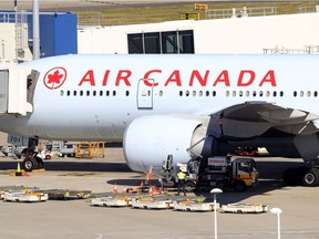 An Air Canada plane sits at a gate at the Sydney Airport in Sydney, Australia.