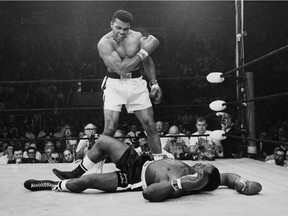 May 25, 1965: World Heavyweight Champion Muhammad Ali (Cassius Clay at the time) stands over fallen challenger, Sonny Liston. Ali won the title from Liston at their first fight in 1964.