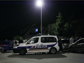 A Police vehicle blocks the road during an assault on June 14, 2016 in Magnanville, 45 kms west of Paris. A man was shot dead during a dramatic police operation in the Paris suburbs late Monday, hours after he had stabbed a police officer to death.
