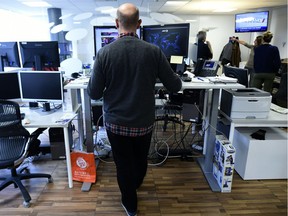 Agence France Presse journalist works while standing: Desks that allow for both standing and sitting became popular after health concerns were raised about being too sedentary.