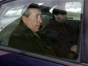 Vito Rizzuto, seen here in January 2004, is taken from a Montreal police station after being arrested in his Montreal home on murder charges in the U.S.