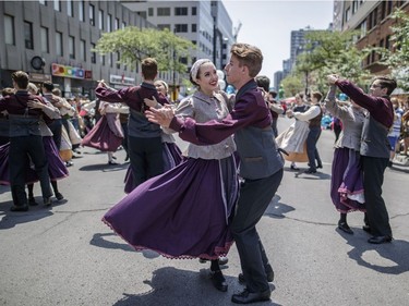 Two people dance as part of the annual Saint-Jean-Baptiste Day parade