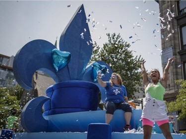 Dancers throw confetti during the Fete Nationale parade in Montreal in 2016.