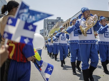 A marching band takes part in the annual Fête Nationale parade for Saint-Jean-Baptiste day on Ste. Catherine street in downtown Montreal on Friday