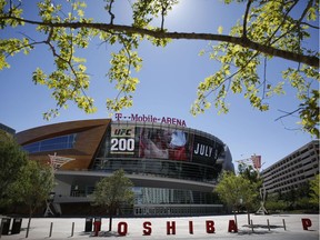 In this June 17, 2016 photo, an advertisement plays on a screen at the T-Mobile Arena in Las Vegas. A National Hockey League plan to expand to Las Vegas is being cheered by fans and backers of a years-long effort to get a pro sports franchise in Sin City, but hockey will have to elbow into a crowded entertainment lineup featuring casino games, celebrity shows, Cirque du Soleil productions and pulsing nightclubs – not to mention boxing matches, UFC fights and events like the National Finals Rodeo.