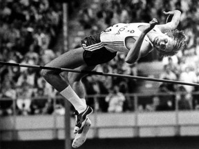 With the Olympic flame in the background Canadian Greg Joy makes his final high jump winning the silver medal for Canada during the 1976 Olympic Games held in Montreal.