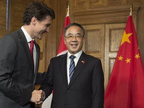 Canadian Prime Minister Justin Trudeau speaks with Hu Chunhua, Politburo Member of the Communist Party of China and Party Secretary of Guangdong Province before a meeting in the prime minister's office on Parliament Hill in Ottawa, Tuesday, May 10, 2016.